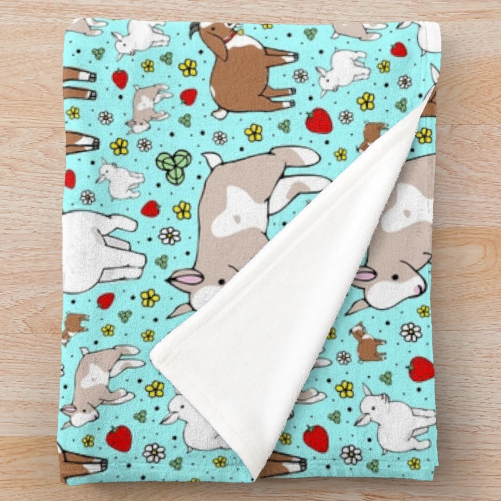 Soft and cuddly plush blanket with a blue and white goat pattern design