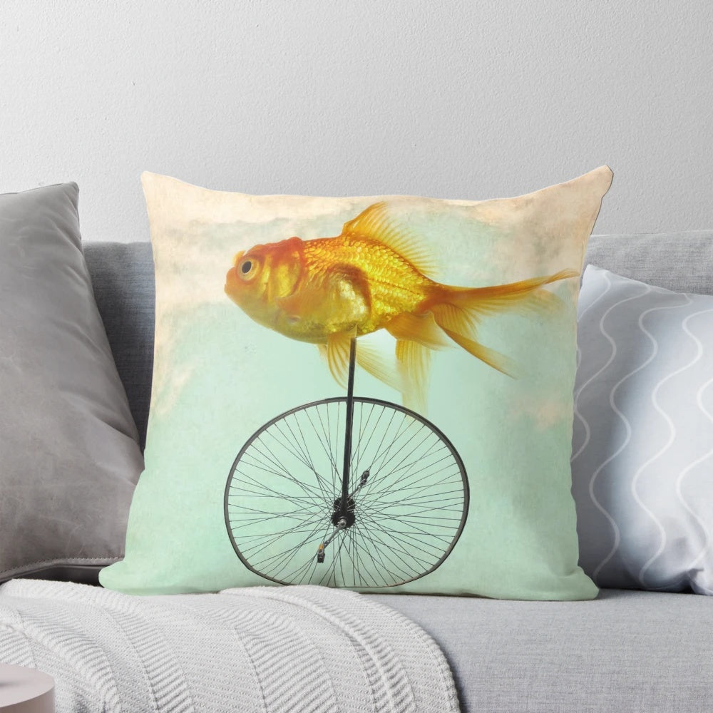 Goldfish riding a unicycle, an endearing and appealing decorative pillow design