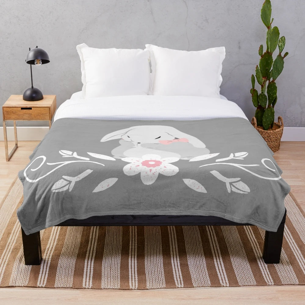 Soft and cozy grey and white bunny rabbit plush blanket with white floral design