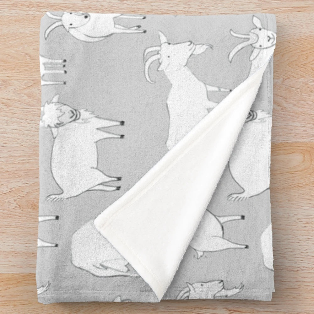 Grey plush blanket with a cute pattern of goats playing