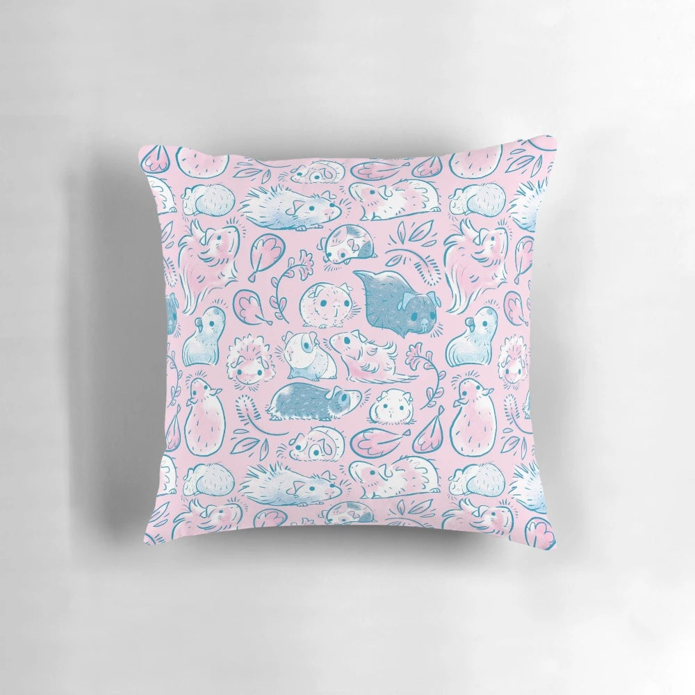 Cozy guinea pigs snuggling together in a soft, pink pillow with a floral pattern
