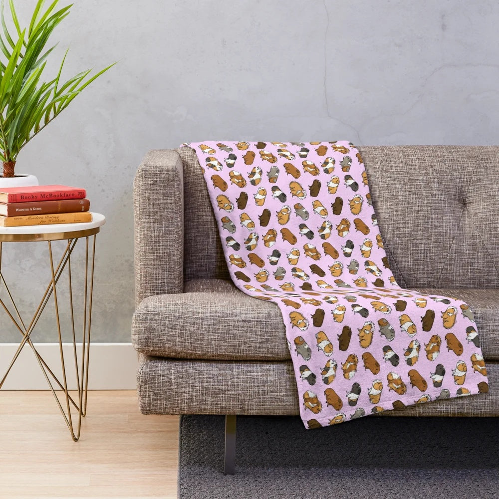 Soft and cuddly guinea pig plush blanket with a repeating pattern design