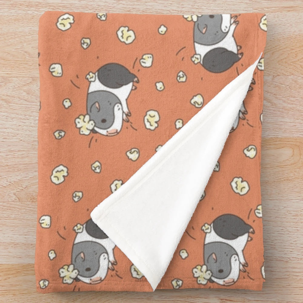 Cute gray and white guinea pig popcorning on a plush blanket with a kawaii pattern design