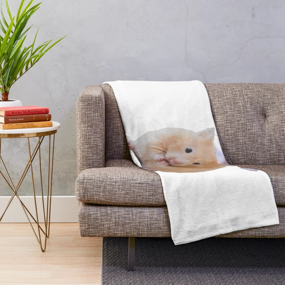 Cute hamster wearing a Christmas hat on a plush blanket