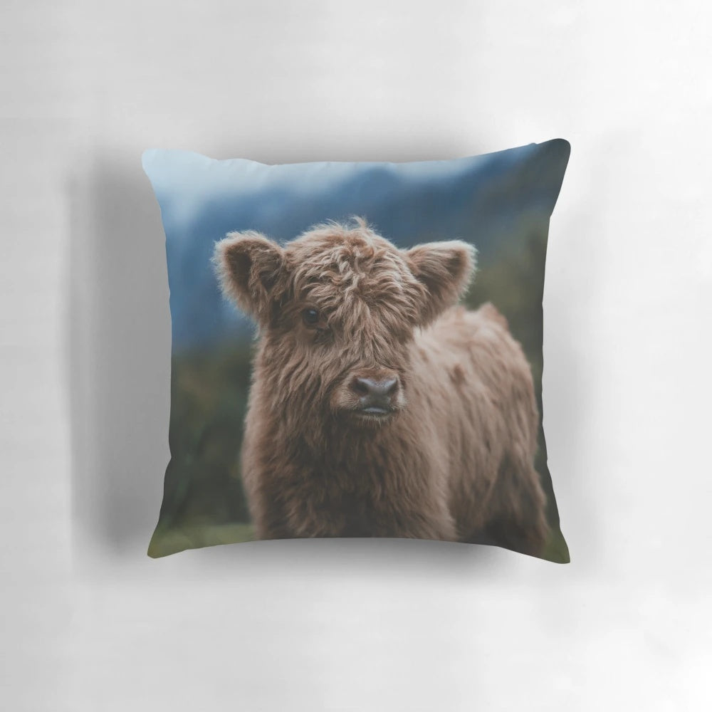 Soft and fluffy highland cow calf pillow, perfect for snuggling and decorating