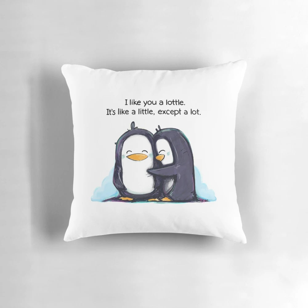 Cute and cuddly penguins hugging on a soft, plush pillow with the text 'I Like You a Lottle'