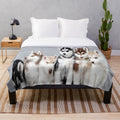 Soft and cuddly plush blanket featuring adorable husky puppies