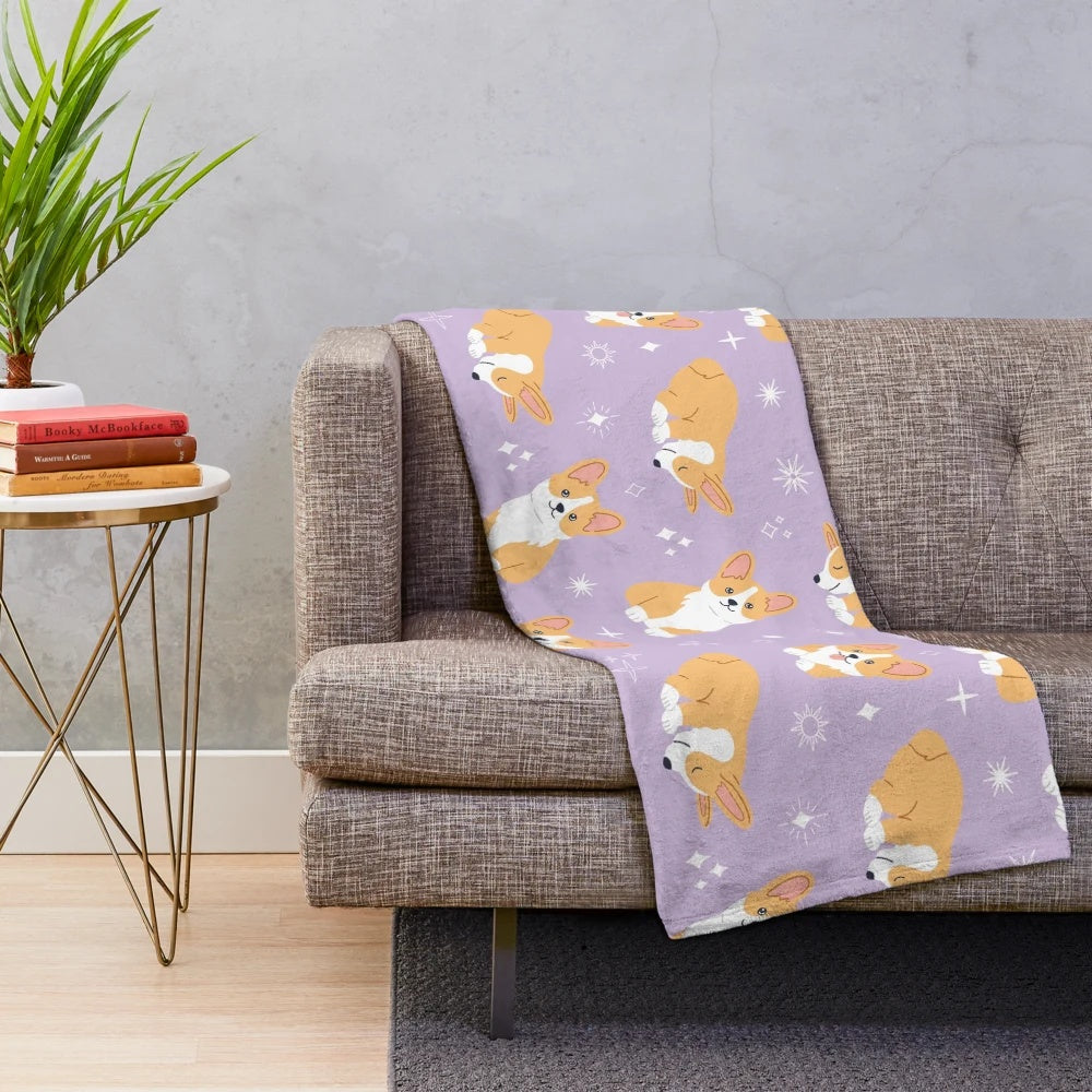 Jolly corgis in a cute and colorful pattern on a purple plush blanket