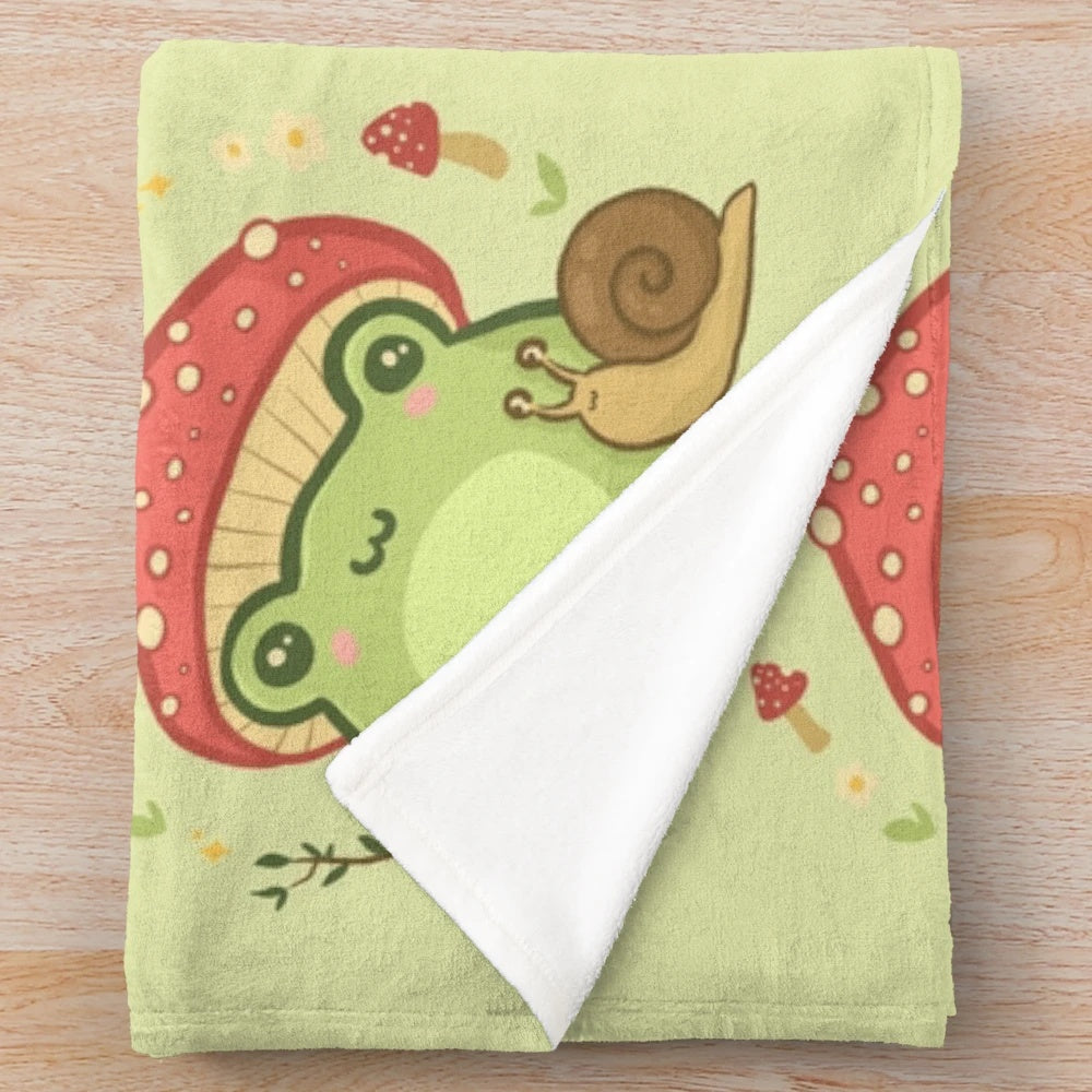 Cute kawaii frog plush blanket featuring a frog wearing a toadstool mushroom hat and a snail
