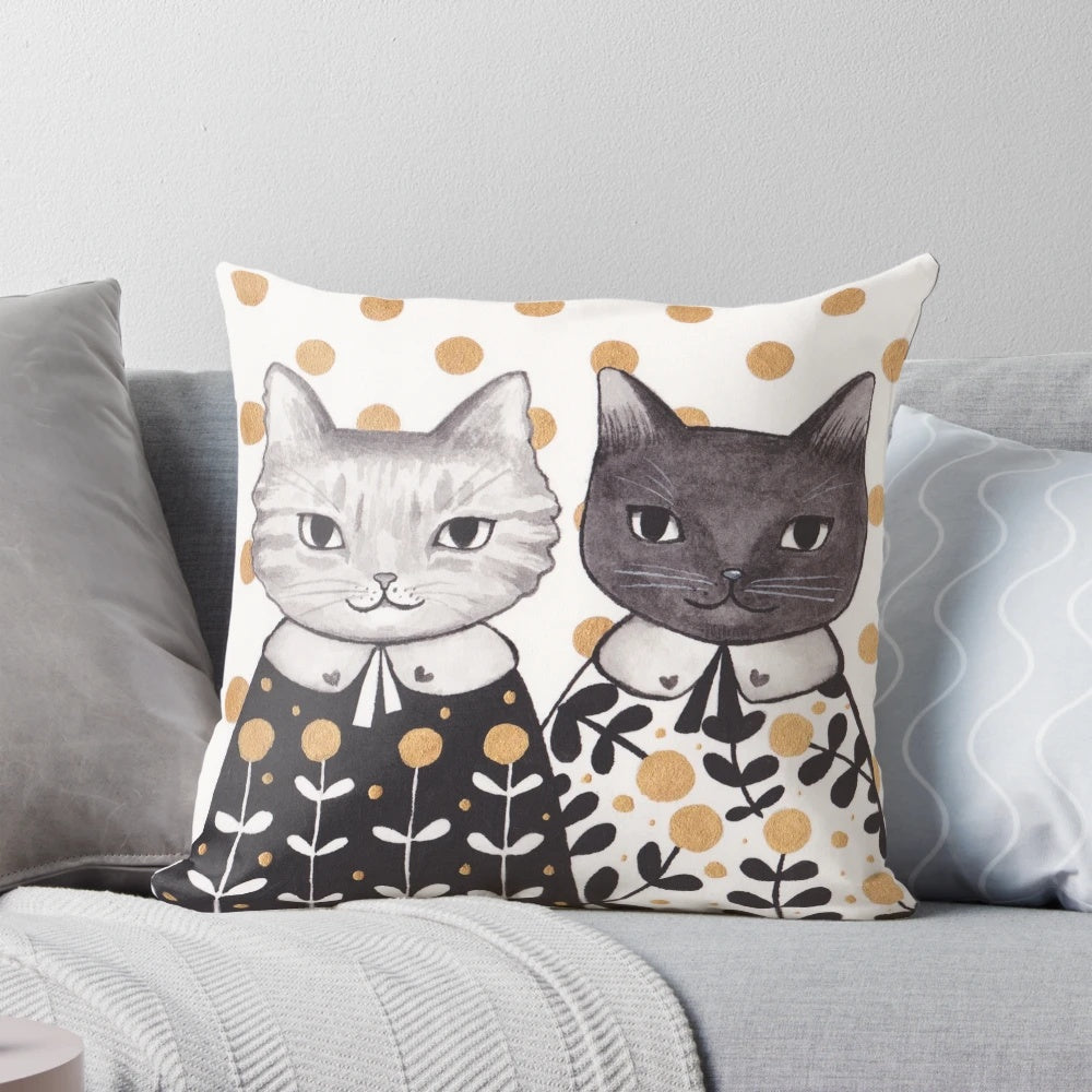 Colorful kitten pillow with capes in a floral pattern.