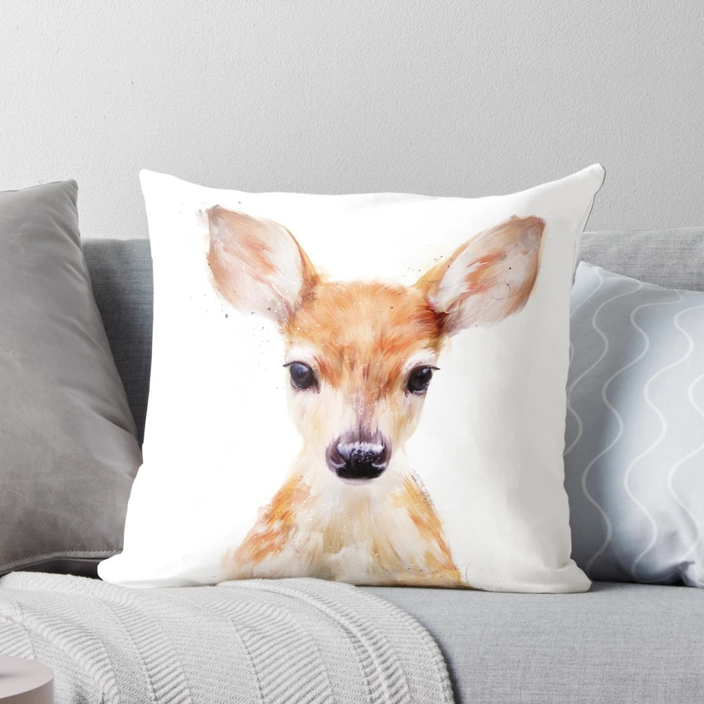 A small, soft plush pillow in the shape of a cute little deer, perfect for nature and wildlife enthusiasts.