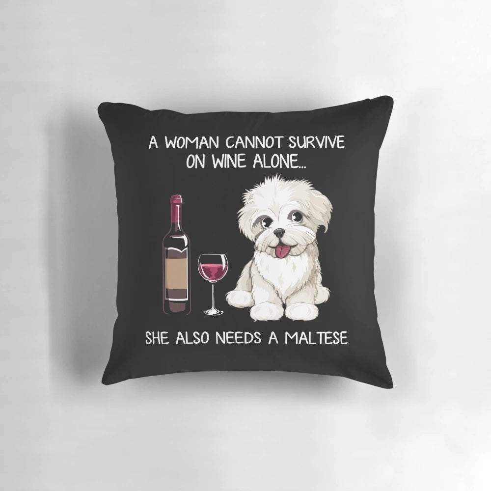 A fluffy white Maltese dog wearing a wine glass print bandana, resting on a decorative pillow.