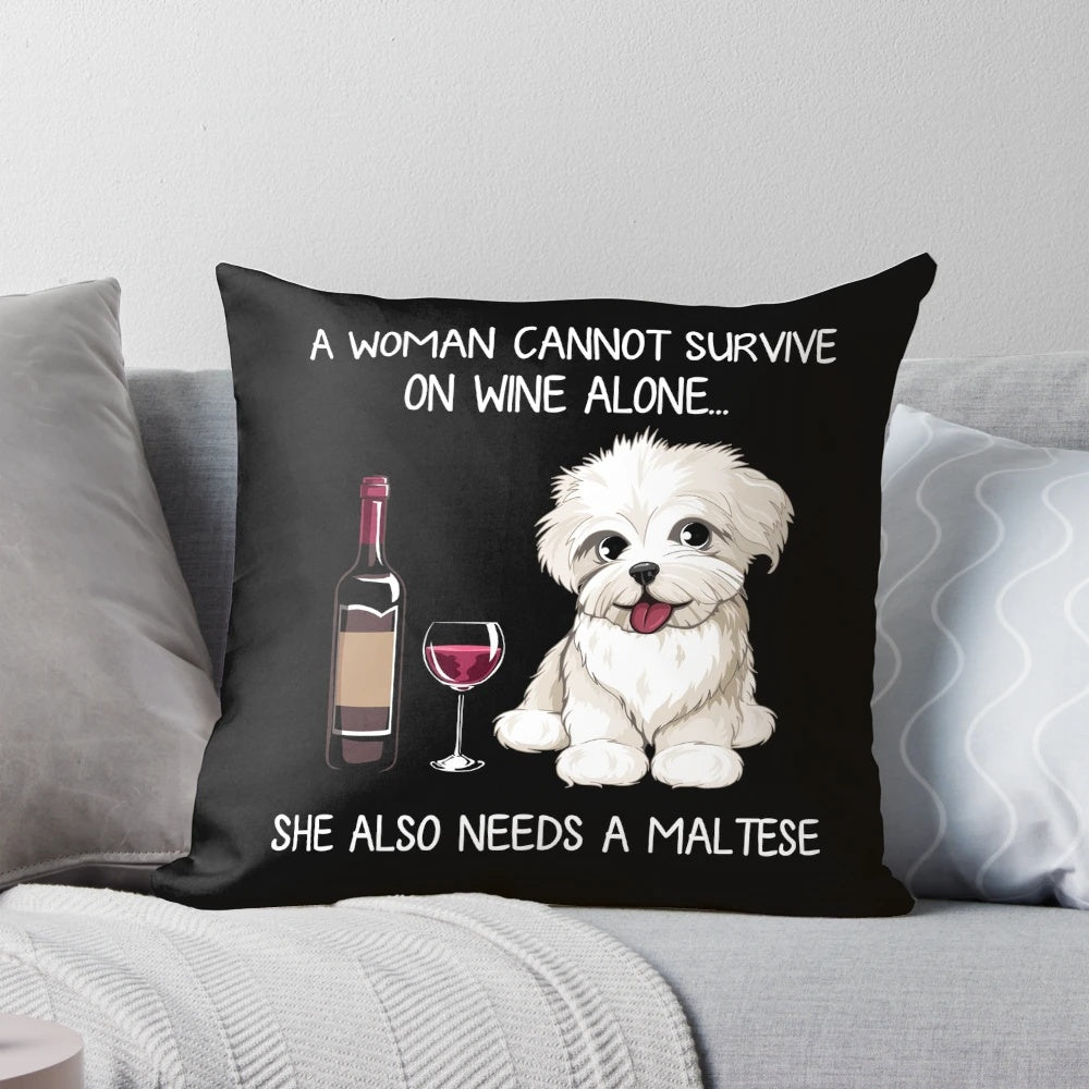 A fluffy white Maltese dog wearing a wine glass print bandana, resting on a decorative pillow.
