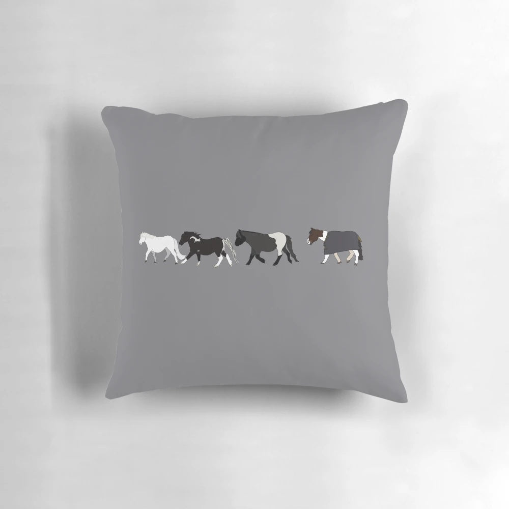 A plush, mini parade pillow featuring a design of small, playful horses.