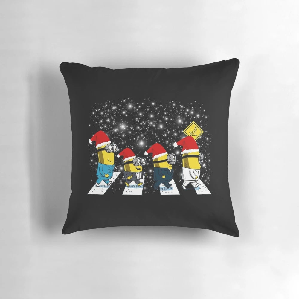 Plush minions walk in Christmas-themed pillow