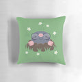 A decorative pillow featuring a pattern of cute, cartoon-style moles wearing eyeglasses and surrounded by grass and white flowers.