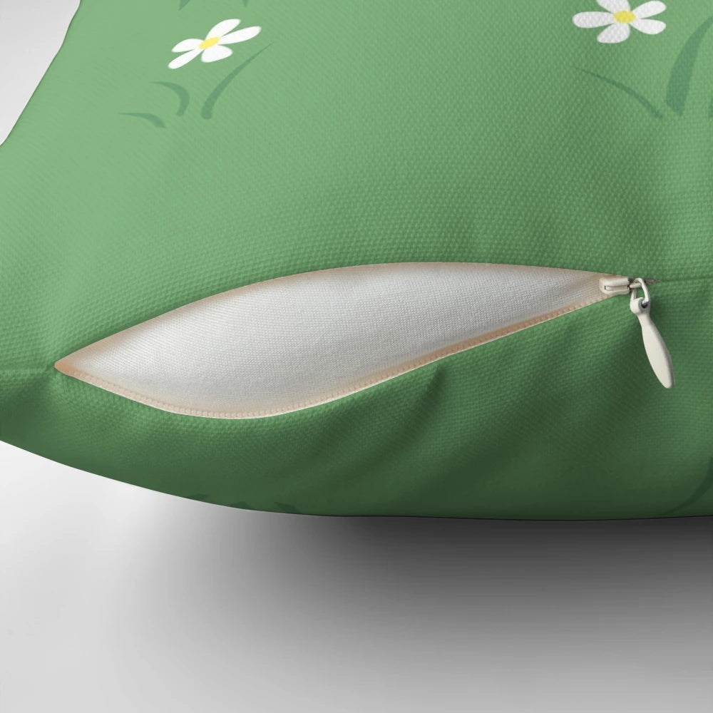 A decorative pillow featuring a pattern of cute, cartoon-style moles wearing eyeglasses and surrounded by grass and white flowers.