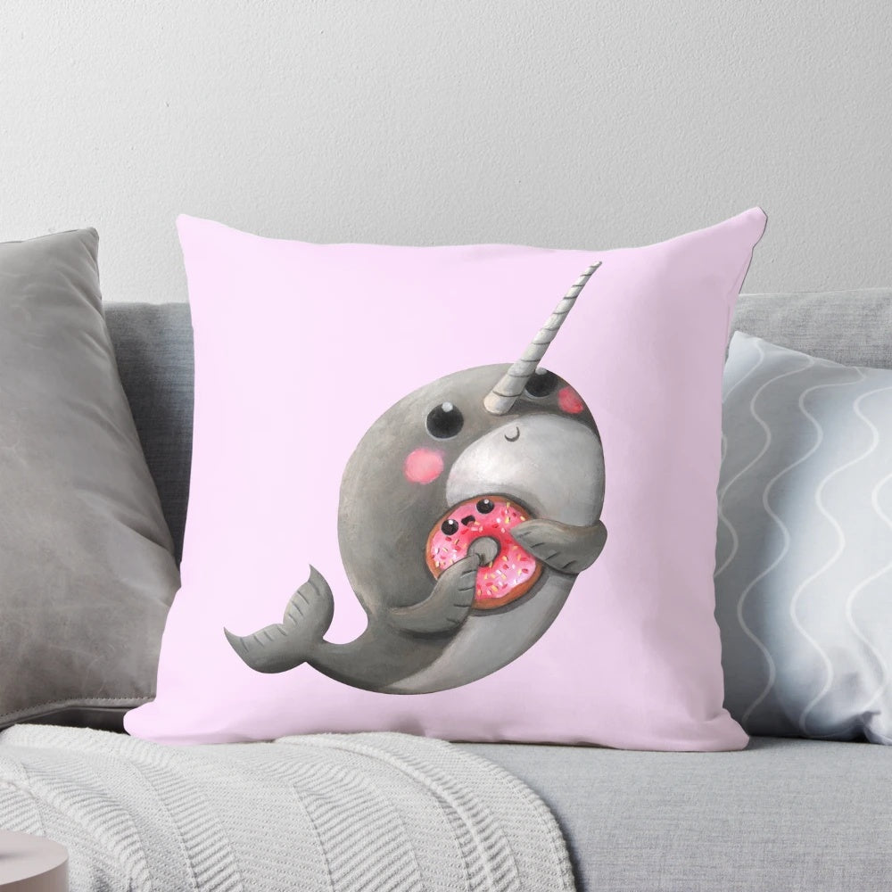 Cute plush narwhal with donut throw pillow, perfect for decorating a child's room or nursery.