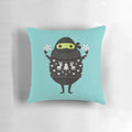 Cute cartoon illustration of Ninjacado, the avocado ninja, wearing an ugly holiday sweater on a plush decorative pillow.
