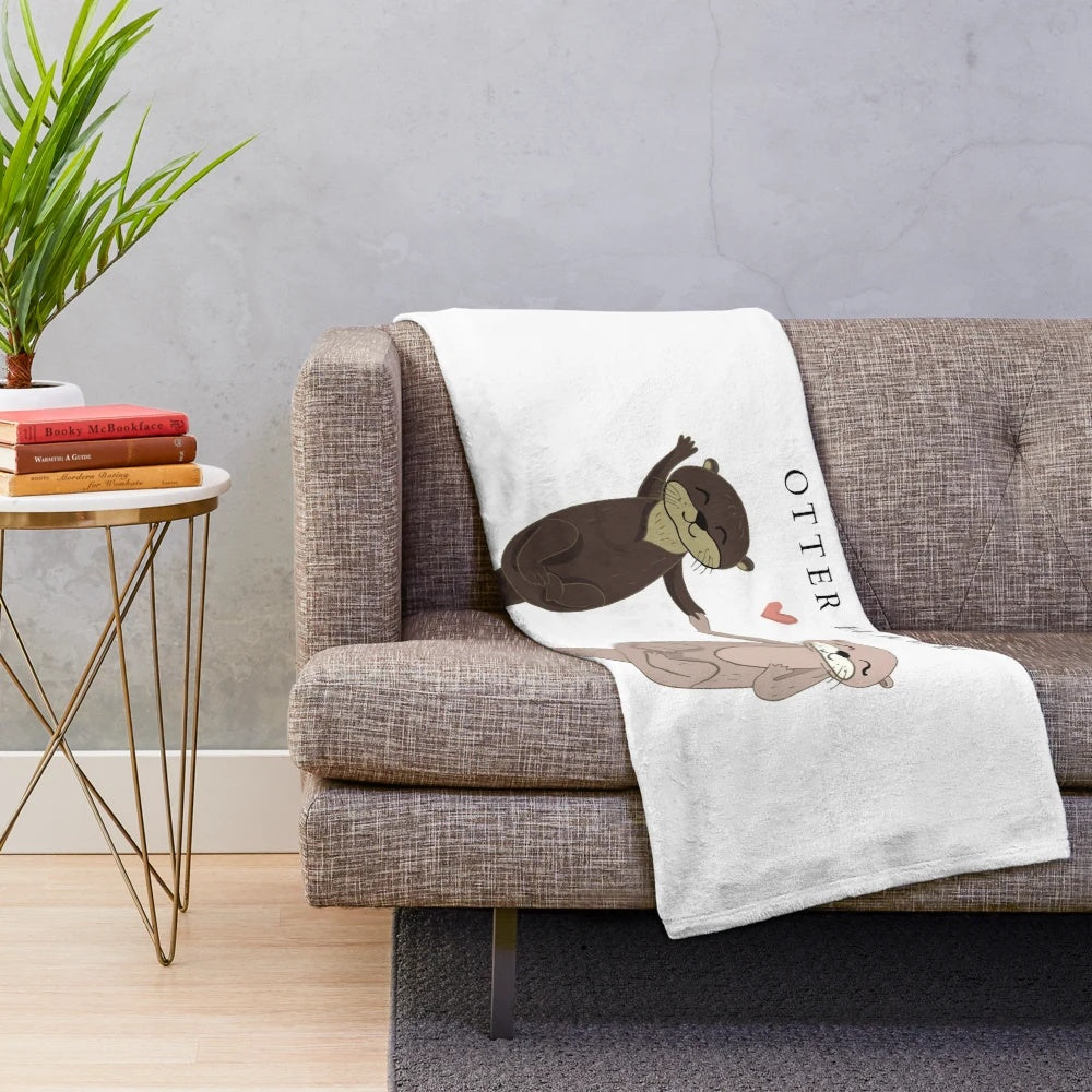 Soft and cozy plush blanket featuring a sweet otter couple design