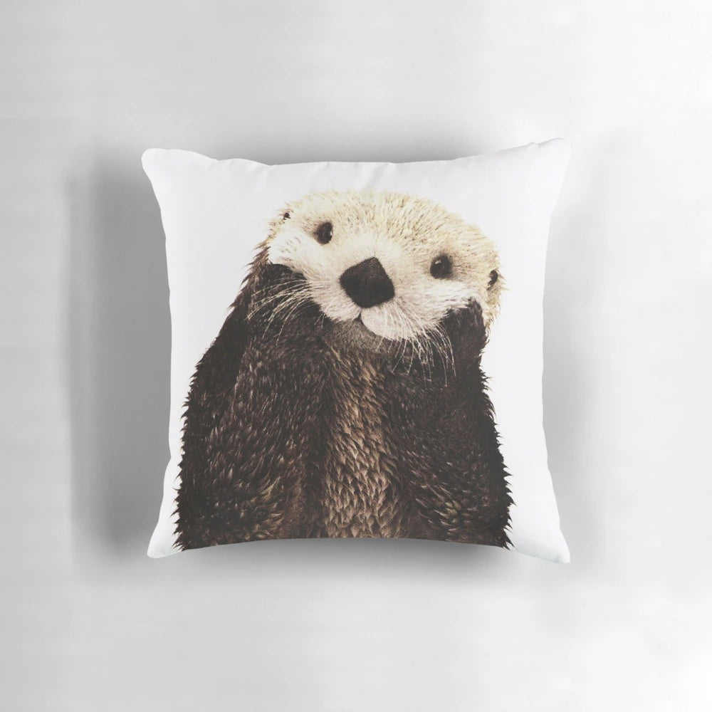 Soft, plush pillow featuring a playful otter with a big smile, perfect for adding a touch of whimsy to any room.