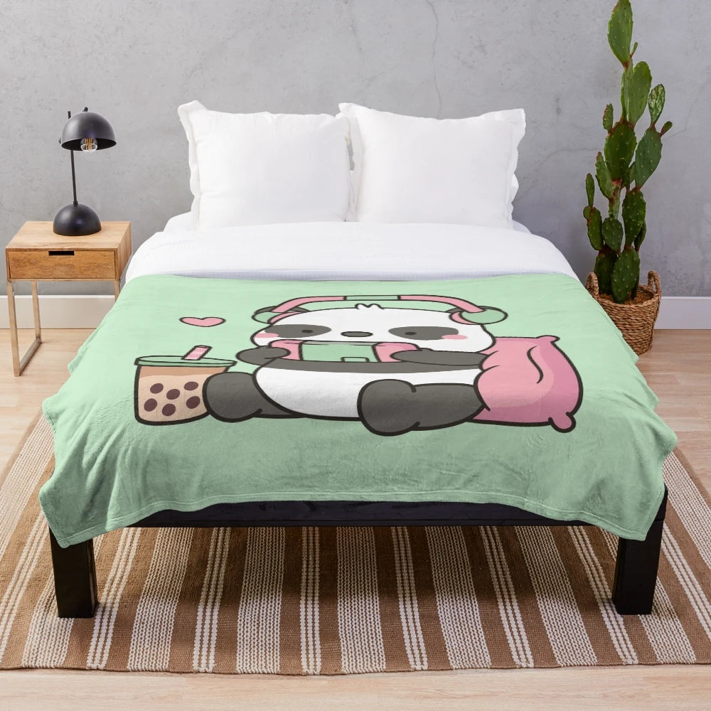 Cute panda character with headphones and gaming accessories on a soft plush blanket