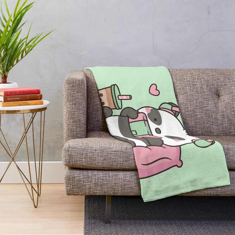 Cute panda character with headphones and gaming accessories on a soft plush blanket
