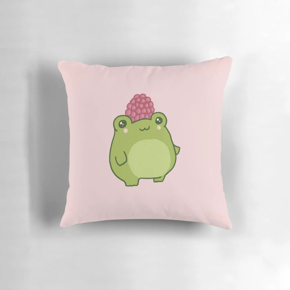 Soft, plush pillow featuring a pastel raspberry colored frog in a cute and chubby cottagecore style design.