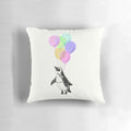 Soft, plush penguin-shaped pillow in black, white and pink with a whimsical balloon design, perfect for a baby nursery or child's bedroom.