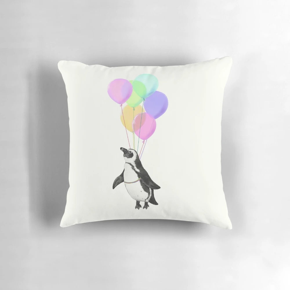 Soft, plush penguin-shaped pillow in black, white and pink with a whimsical balloon design, perfect for a baby nursery or child's bedroom.