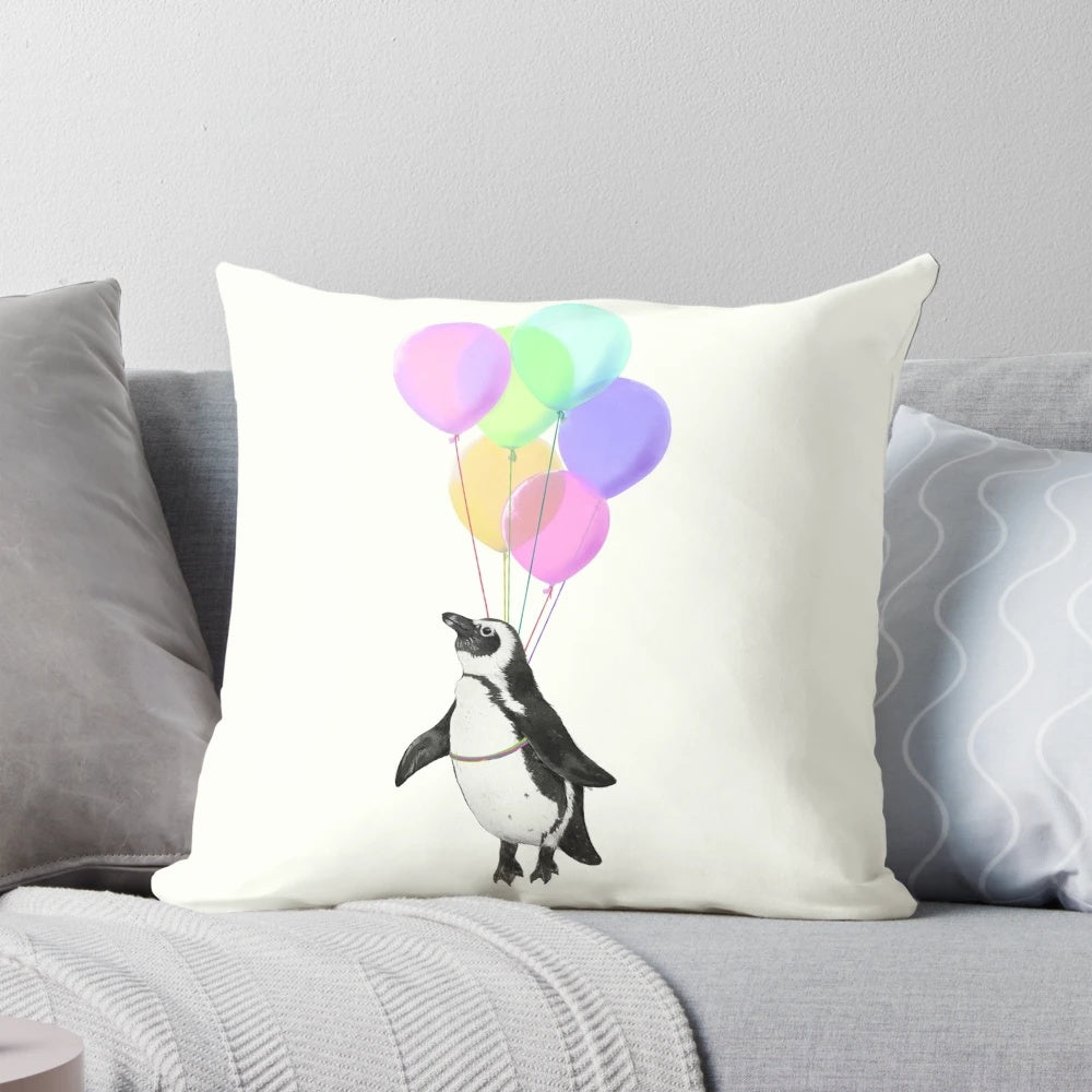 Soft, plush penguin-shaped pillow in black, white and pink with a whimsical balloon design, perfect for a baby nursery or child's bedroom.