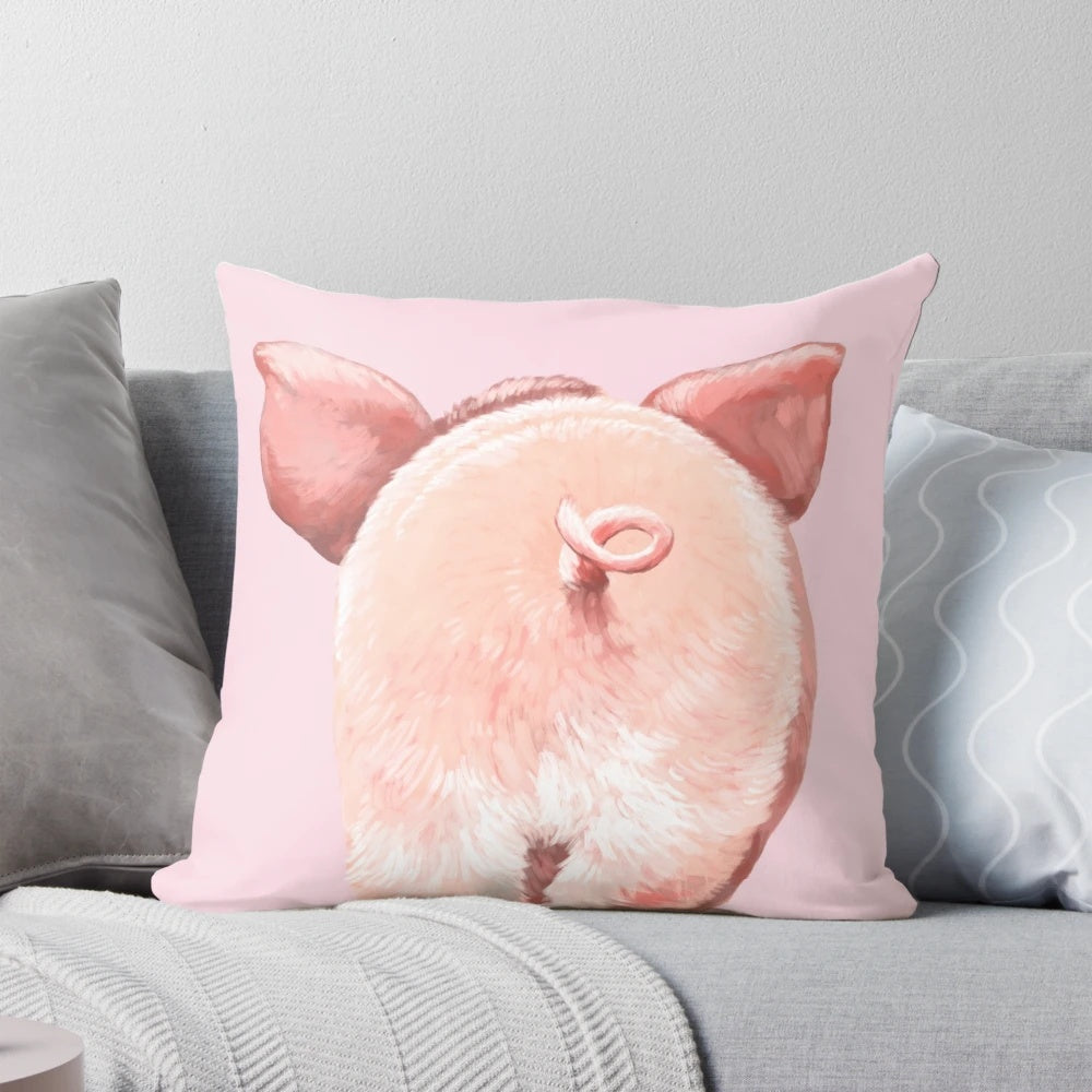 A soft, plush pink pillow in the shape of a cute piglet with a curly tail