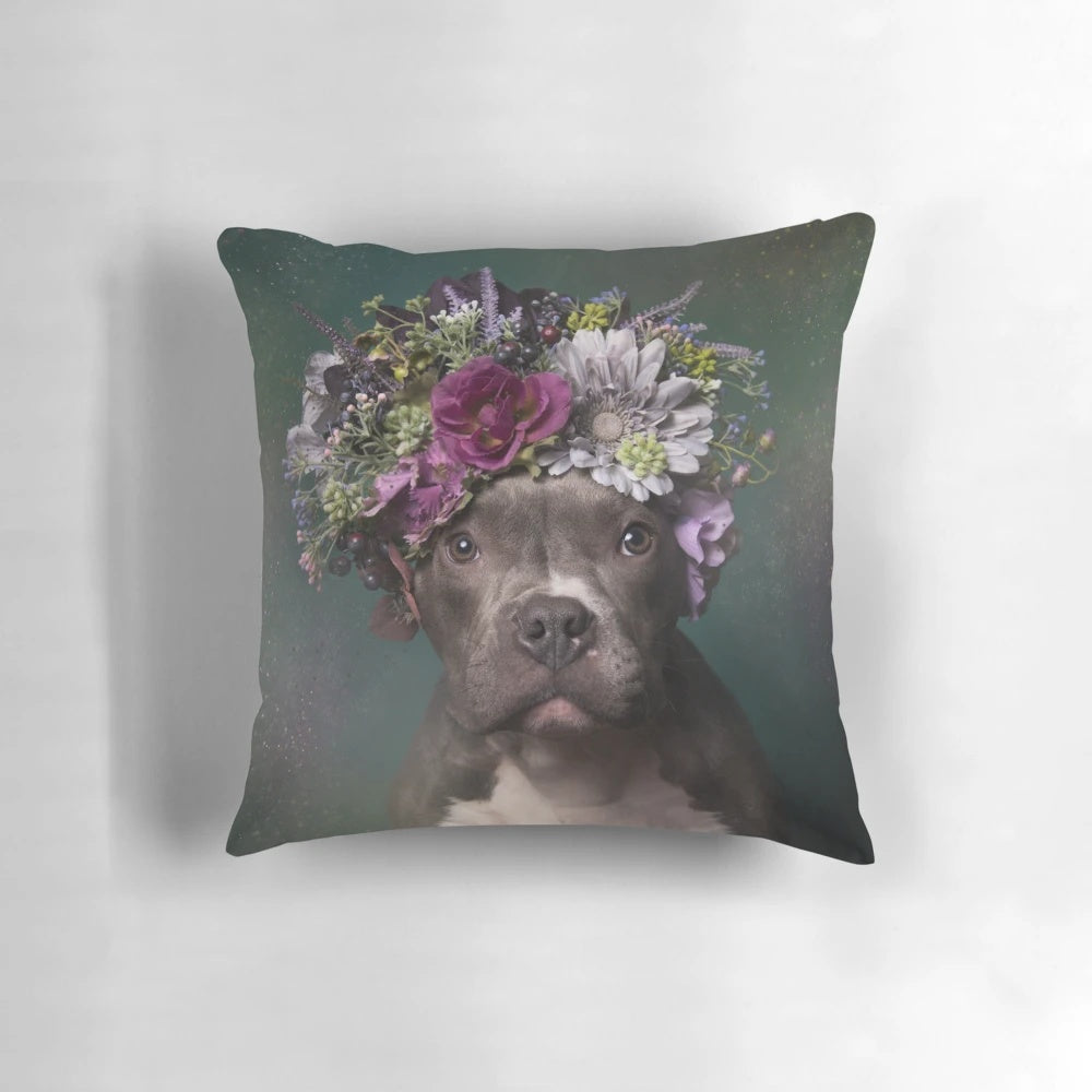 A tater tot-shaped pillow featuring a pit bull wearing a beautiful flower crown