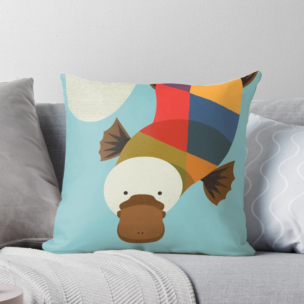 Whimsical platypus-themed decorative pillow with geometric patterns, perfect for a nature-inspired nursery or child's room.