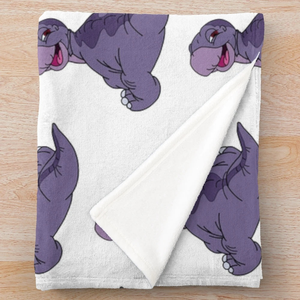 Plush blanket with a baby apatosaurus dinosaur from the Land Before Time movie