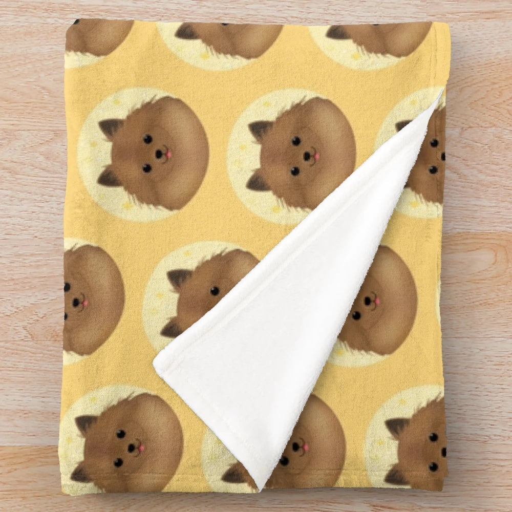 Cute pomchi dog portrait on a plush blanket