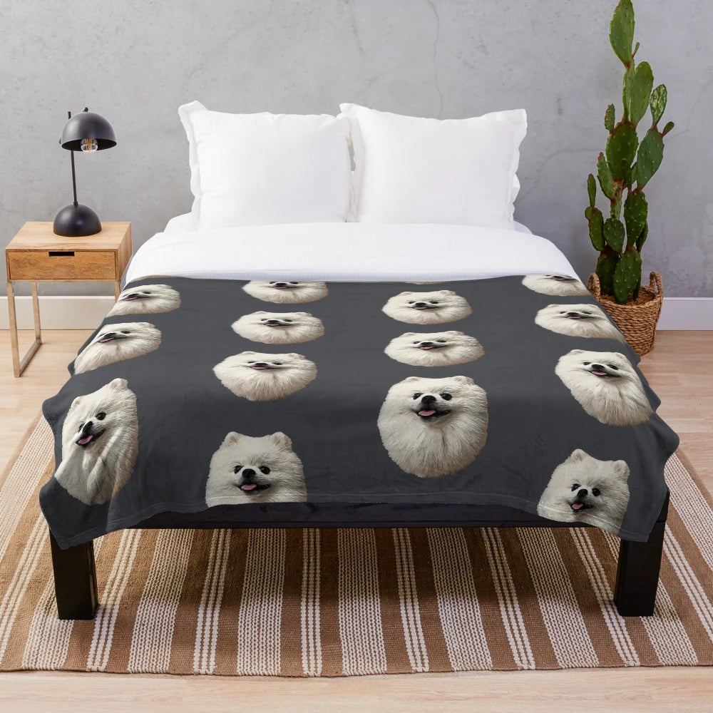 Soft and cozy plush blanket featuring a cute white pomeranian puppy design