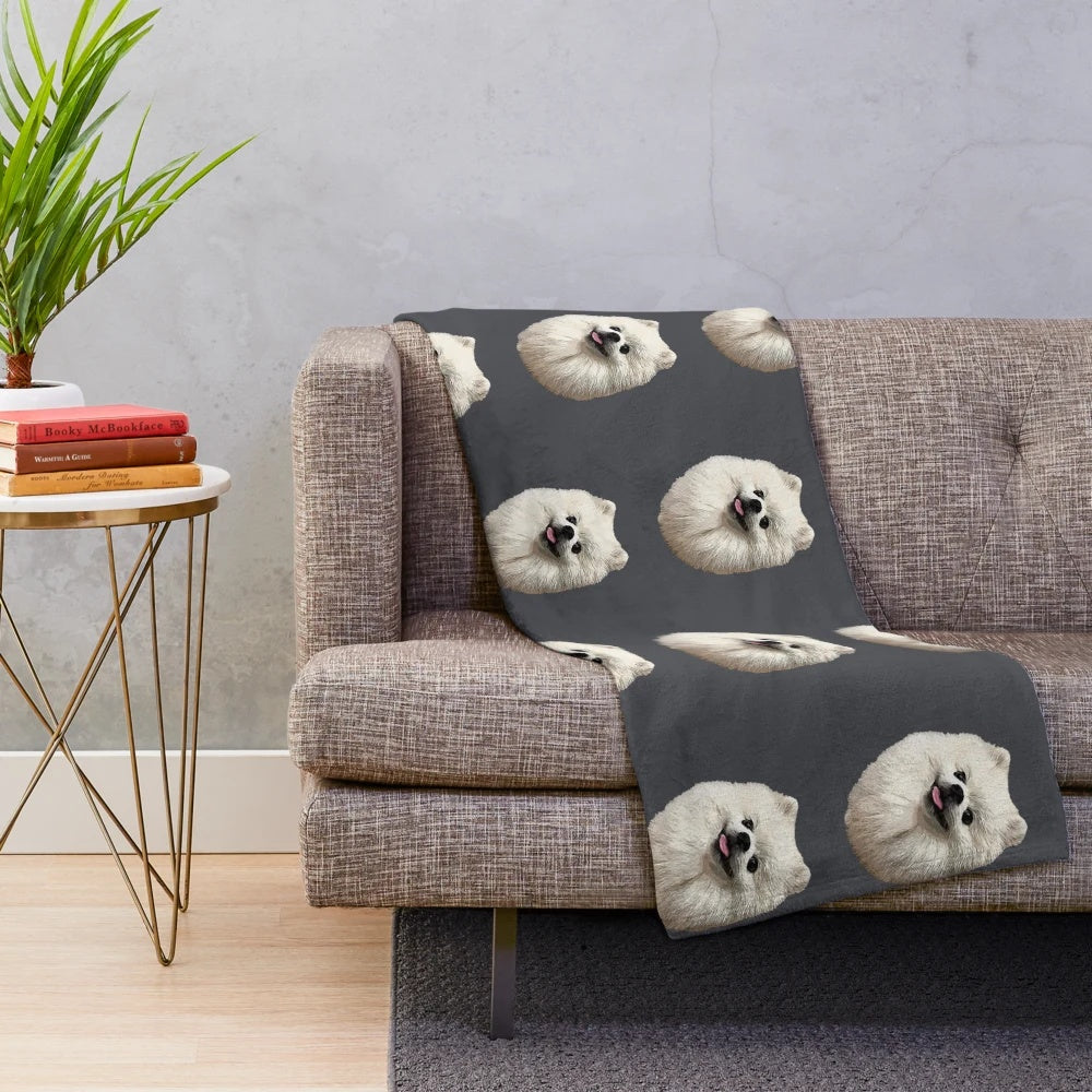 Soft and cozy plush blanket featuring a cute white pomeranian puppy design