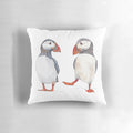Soft, cozy pillow featuring illustrated puffins dancing and playing in the ocean