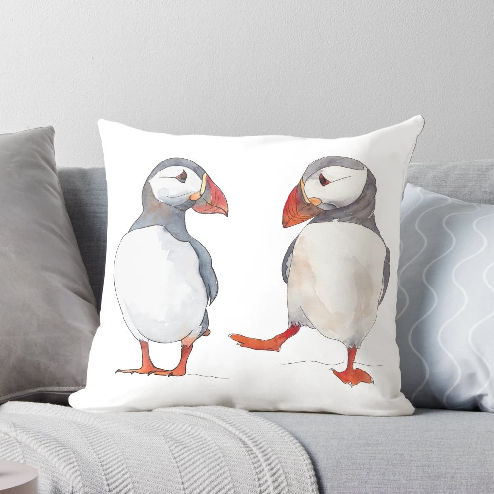 Soft, cozy pillow featuring illustrated puffins dancing and playing in the ocean