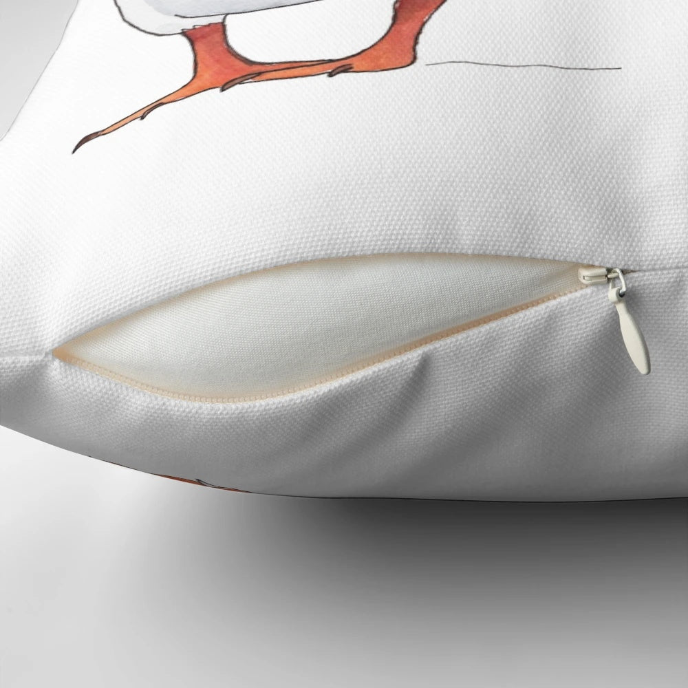 Soft, cozy pillow featuring illustrated puffins dancing and playing in the ocean