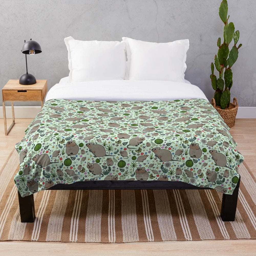 Soft and cozy plush blanket featuring a cute green quokka pattern