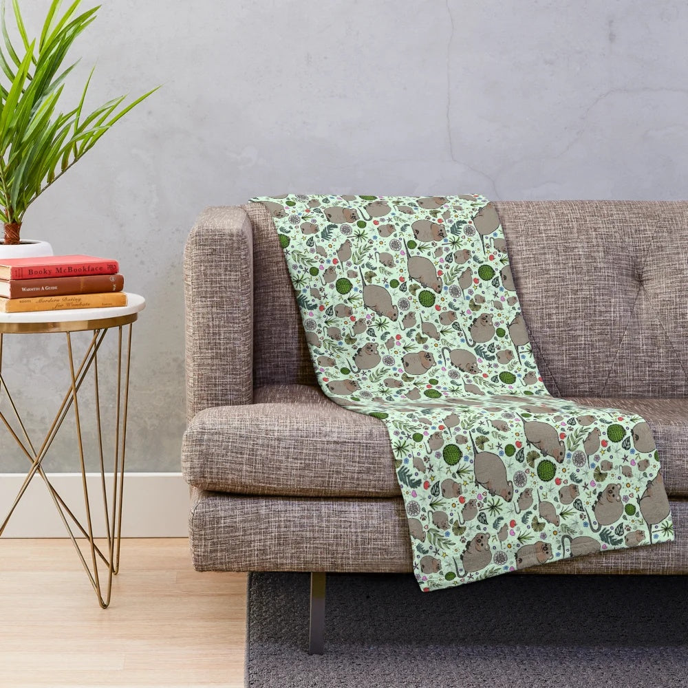 Soft and cozy plush blanket featuring a cute green quokka pattern