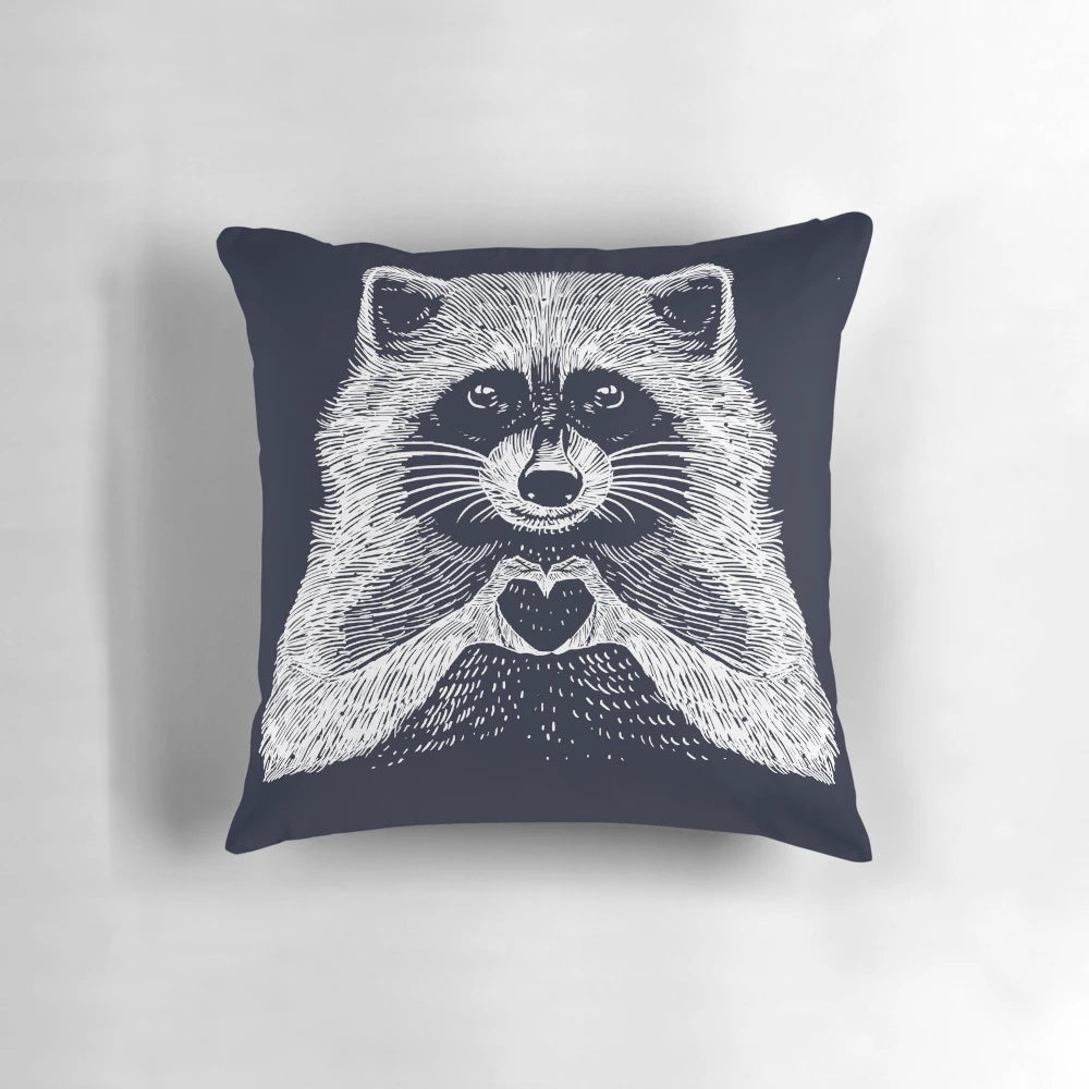 Soft, plush raccoon-shaped pillow with a heart-shaped face and whimsical, hand-drawn illustration