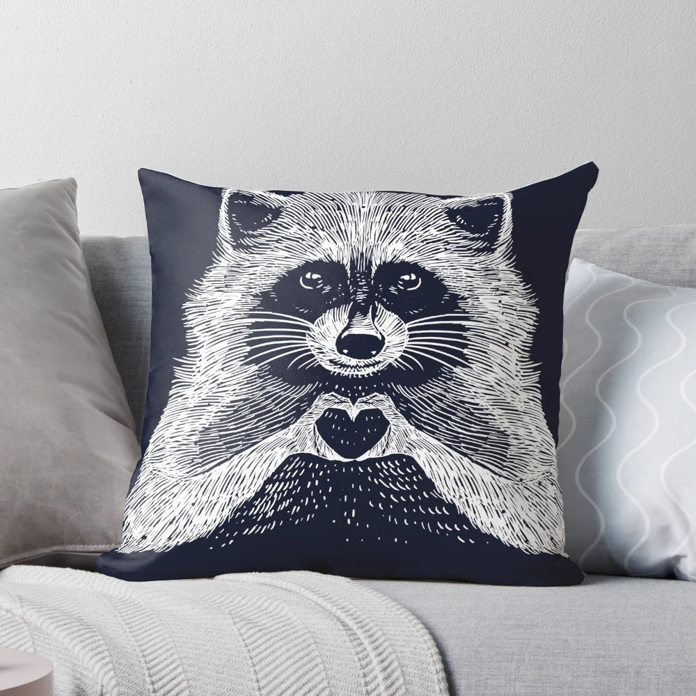 Soft, plush raccoon-shaped pillow with a heart-shaped face and whimsical, hand-drawn illustration