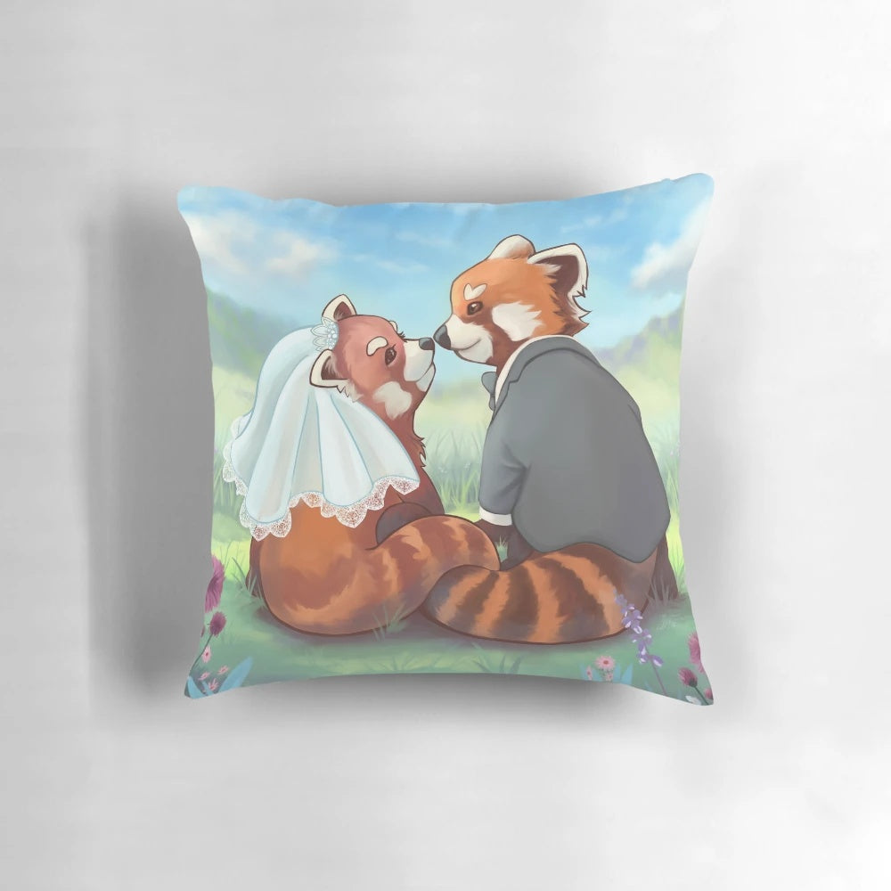 Cute red panda couple cuddling on a decorative pillow