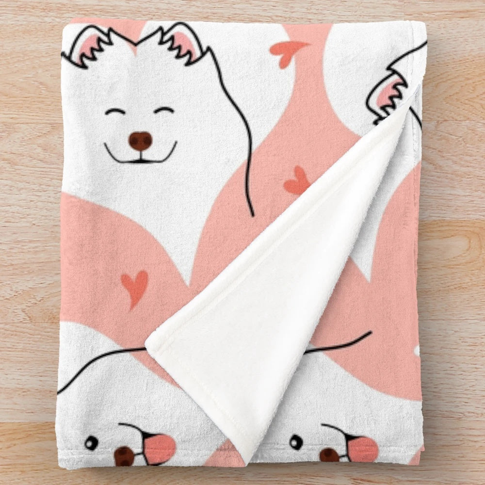 Soft and cuddly pink plush blanket featuring a cute Samoyed dog emoji design