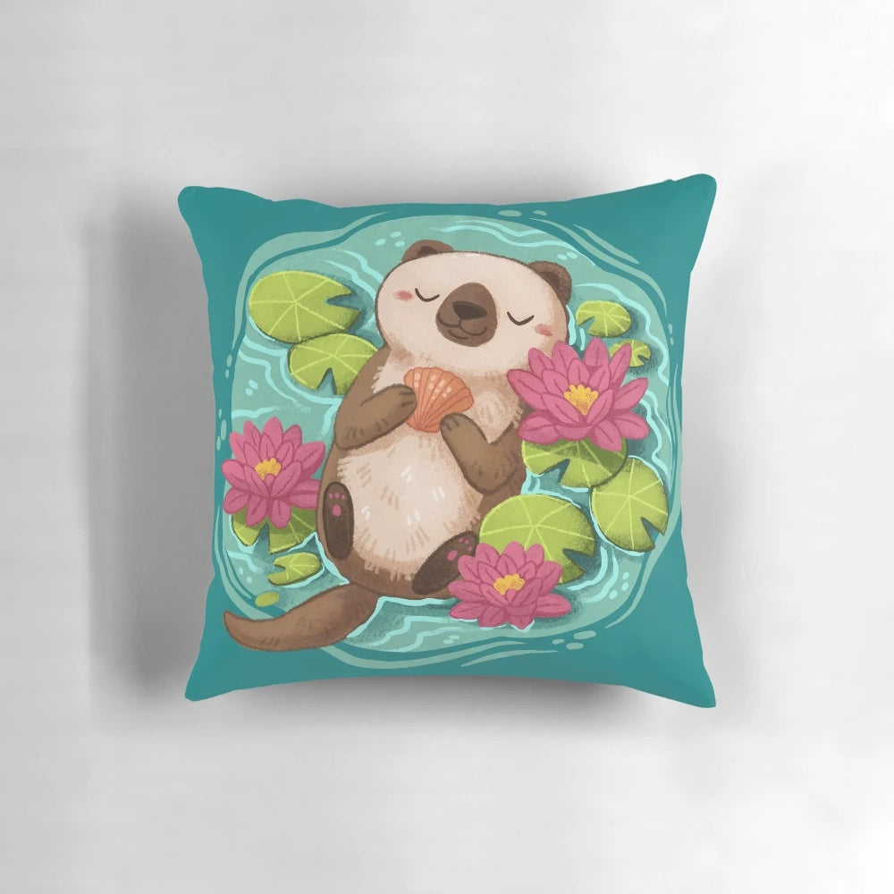 A soft, plush pillow featuring a happy sea otter surrounded by lotus flowers and pond elements.