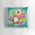 A soft, plush pillow featuring a happy sea otter surrounded by lotus flowers and pond elements.