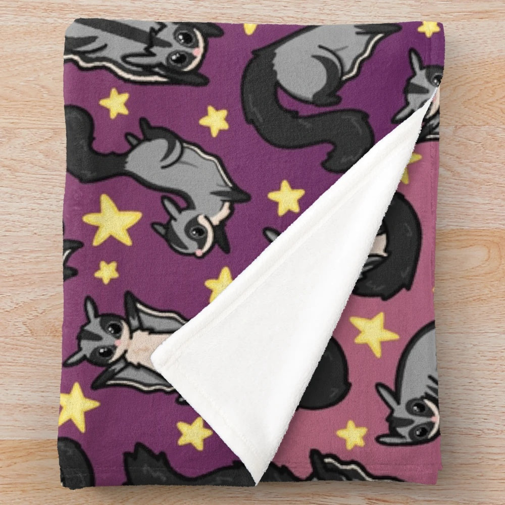 Soft and cozy plush blanket with a cute sugar glider pattern design